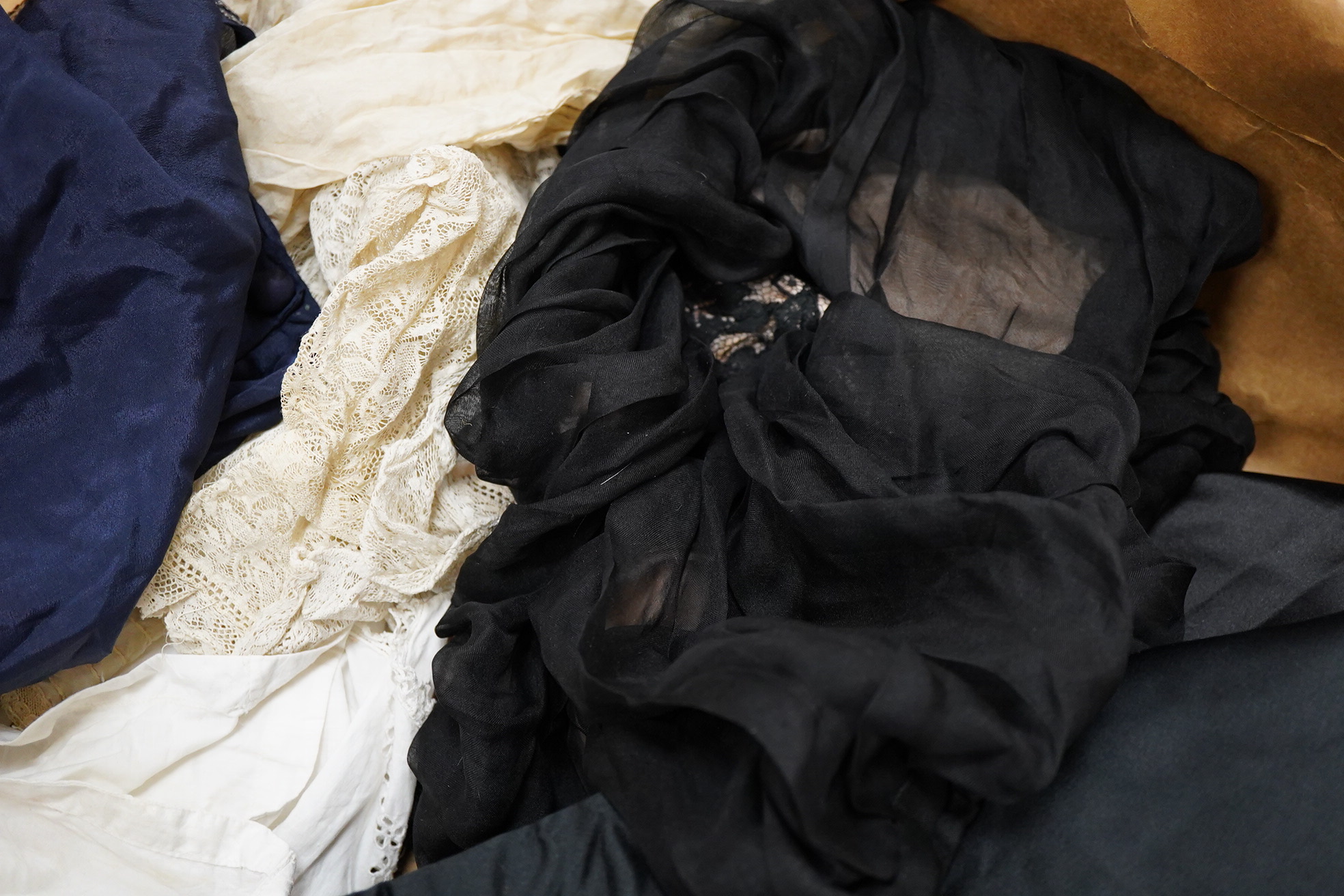 Two Edwardian blouses and three earlier lace camisoles, three black satin partly sewn skirts and later black velvet diamonte decorated evening coat. Condition - the coat, skirts and blouses need repair but are good for T
